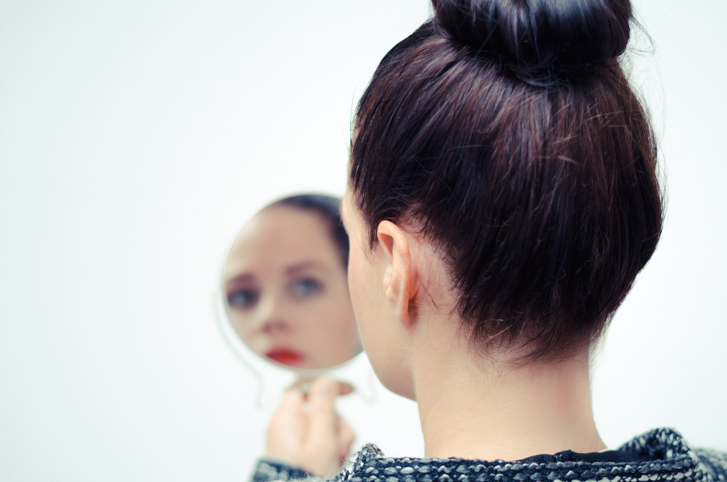 businesswoman looking in the mirror and reflecting